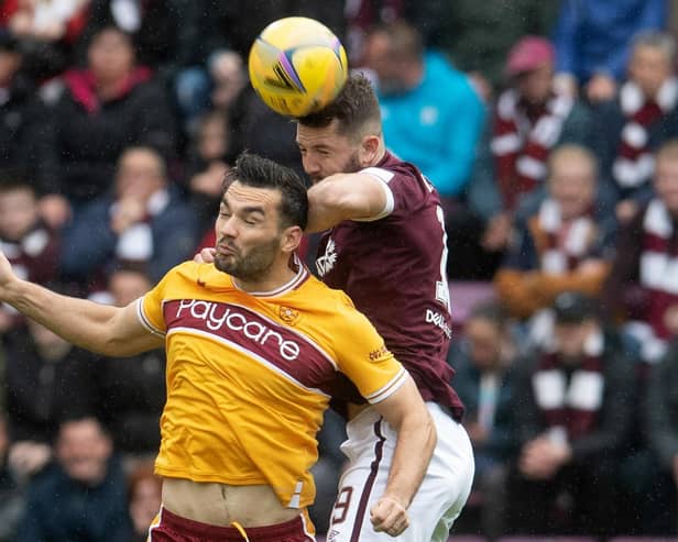 The aerially dominant Craig Halkett climbs over Tony Watt during a match between Hearts and Motherwell at Tynecastle. Picture: SNS