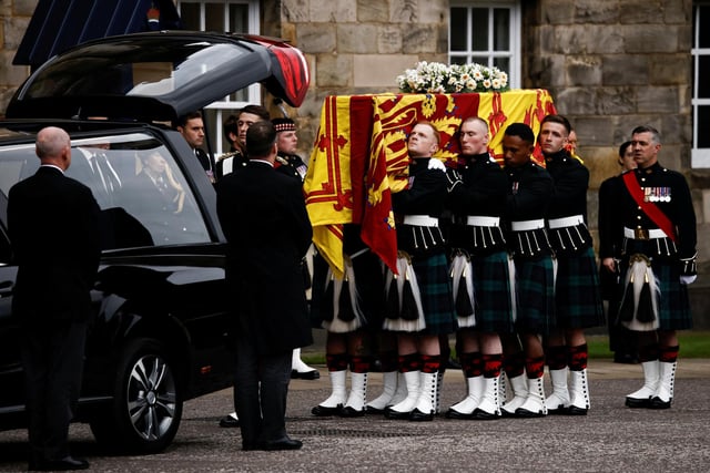 Pallbearers carrying the coffin of Queen Elizabeth II, draped with the Royal Standard of Scotland, as it arrives at Holyroodhouse, Edinburgh where it will lie in rest for a day. Picture date: Sunday September 11, 2022.