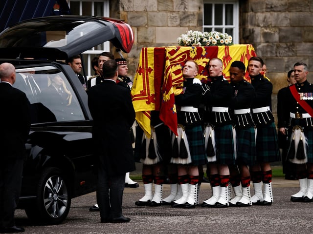 Pallbearers carrying the coffin of Queen Elizabeth II, draped with the Royal Standard of Scotland, as it arrives at Holyroodhouse, Edinburgh where it will lie in rest for a day. Picture date: Sunday September 11, 2022.