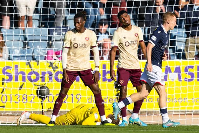 Hearts' Gerald Taylor (centre) scores an own goal to make it 2-0 to Dundee.  (Photo by Craig Foy / SNS Group)