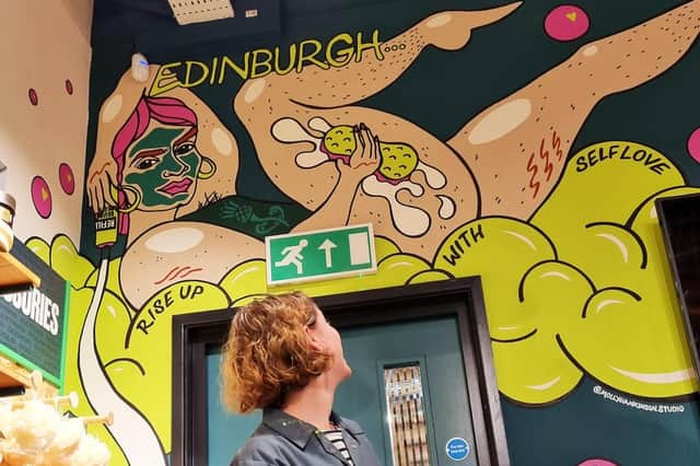 Artist Molly Hankinson and her self-love mural in The Body Shop concept concept store in the St James Quarter.