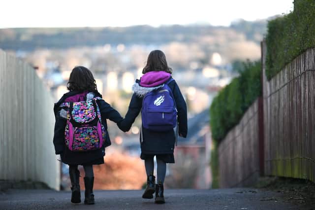 Two children return to the classroom following school holidays. Picture: John Devlin