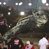 Track marshals clear the debris following the crash of Romain Grosjean of France and Haas F1 during the F1 Grand Prix of Bahrain at Bahrain International Circuit on November 29, 2020 in Bahrain, Bahrain. (Photo by Tolga Bozoglu - Pool/Getty Images)