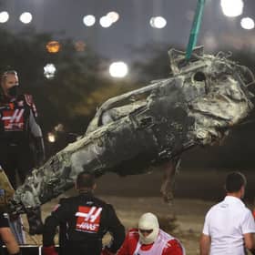 Track marshals clear the debris following the crash of Romain Grosjean of France and Haas F1 during the F1 Grand Prix of Bahrain at Bahrain International Circuit on November 29, 2020 in Bahrain, Bahrain. (Photo by Tolga Bozoglu - Pool/Getty Images)