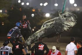 Track marshals clear the debris following the crash of Romain Grosjean of France and Haas F1 during the F1 Grand Prix of Bahrain at Bahrain International Circuit on November 29, 2020 in Bahrain, Bahrain. (Photo by Tolga Bozoglu - Pool/Getty Images)