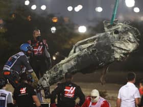 Track marshals clear the debris following the crash of Romain Grosjean of France and Haas F1 during the F1 Grand Prix of Bahrain at Bahrain International Circuit on November 29, 2020 in Bahrain, Bahrain. (Photo by Tolga Bozoglu - Pool/Getty Images)