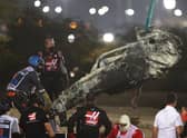 Track marshals clear the debris following the crash of Romain Grosjean of France and Haas F1 during the F1 Grand Prix of Bahrain at Bahrain International Circuit on November 29, 2020 in Bahrain, Bahrain. (Photo by Tolga Bozoglu - Pool/Getty Images)