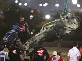 Track marshals clear the debris following the crash of Romain Grosjean of France and Haas F1 during the F1 Grand Prix of Bahrain at Bahrain International Circuit on November 29, 2020 in Bahrain, Bahrain. (Photo by Tolga Bozoglu - Pool/Getty Images)
