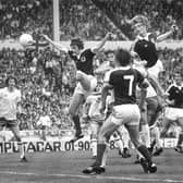 Gordon McQueen powers home a header to set Scotland up for a famous 2-1 victory over England at Wembley in 1977. Pic: Denis Straughan.