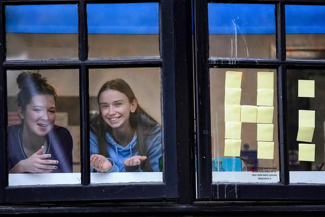 Students from Glasgow University look out of the windows of the Murano Street student village.