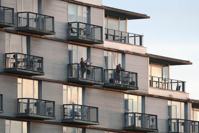 Residents applaud from their block of flats in Glasgow as they to salute local heroes during Thursday's nationwide Clap for Carers initiative to recognise and support NHS workers and carers fighting the coronavirus pandemic.