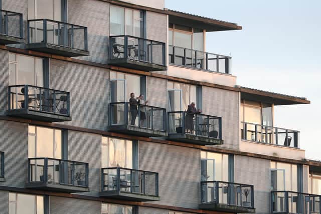 Residents applaud from their block of flats in Glasgow as they to salute local heroes during Thursday's nationwide Clap for Carers initiative to recognise and support NHS workers and carers fighting the coronavirus pandemic.
