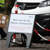 Staff from the Scottish Ambulance Service carry boxes of test kits at a mobile Covid testing unit. Picture: PA Media.