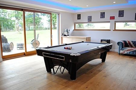 The ground floor features a full-size pool table.