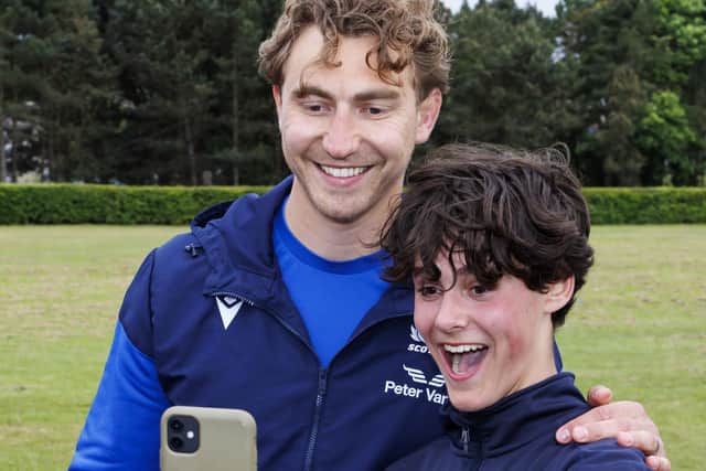 Scotland captain Jamie Ritchie poses for a picture with a fan during a Papa John's Tartan Touch event at Madras Rugby Club. (Photo by Mark Scates / SNS Group)