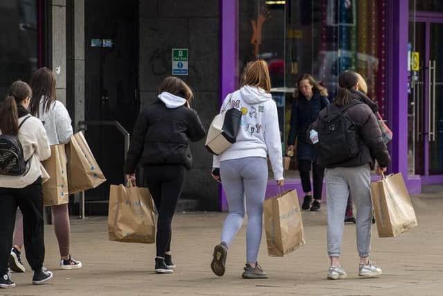 Shoppers pictured carrying Primark bags on Monday morning after they have visited the store for the first time in months. Photo: Lisa Ferguson
