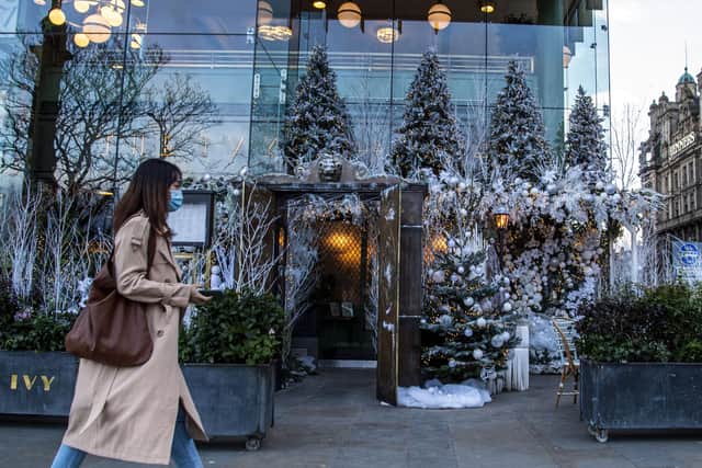 Shopper walks past Ivy in the Square, Edinburgh