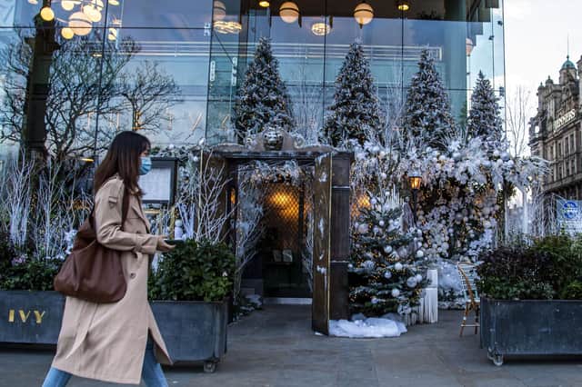 Shopper walks past Ivy in the Square, Edinburgh