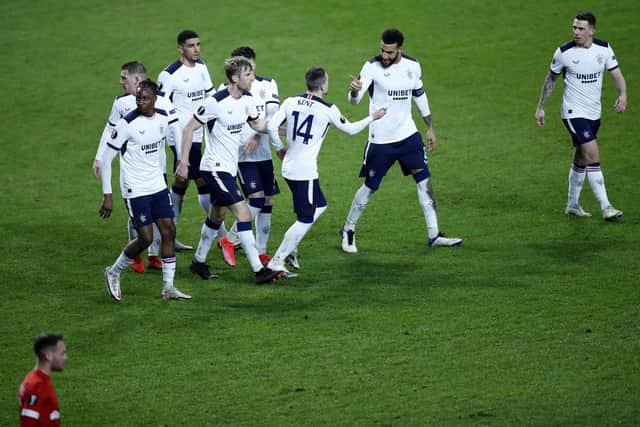 Rangers' Ryan Kent, ceebrates with teammates after scoring his sides third goal during the Europa League round of 32 first leg soccer match between Antwerp and Rangers at the Bosuil stadium in Antwerp, Belgium, Thursday, Feb. 18, 2021. (AP Photo/Francisco Seco)