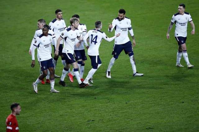 Rangers' Ryan Kent, ceebrates with teammates after scoring his sides third goal during the Europa League round of 32 first leg soccer match between Antwerp and Rangers at the Bosuil stadium in Antwerp, Belgium, Thursday, Feb. 18, 2021. (AP Photo/Francisco Seco)