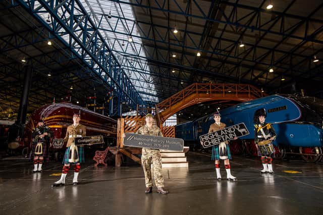 Soldiers from the Royal Regiment of Scotland at the National Railway Museum in York with some of the nameplates to be auctioned online. Picture: LNER/Charlotte Graham