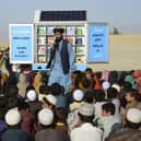 In this photograph from May last year, Matiullah Wesa, head of PenPath and advocate for girls' education in Afghanistan, speaks to children during a class next to his mobile library in Spin Boldak district of Kandahar Province.