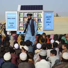 In this photograph from May last year, Matiullah Wesa, head of PenPath and advocate for girls' education in Afghanistan, speaks to children during a class next to his mobile library in Spin Boldak district of Kandahar Province.
