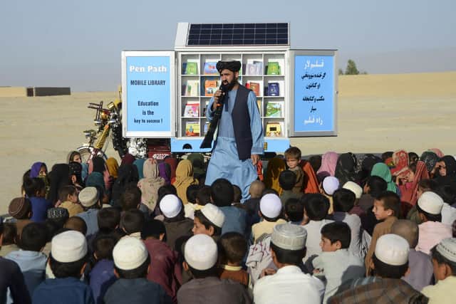 In this photograph from May last year, Matiullah Wesa, head of PenPath and advocate for girls' education in Afghanistan, speaks to children during a class next to his mobile library in Spin Boldak district of Kandahar Province.
