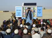 In this photograph from May last year, Matiullah Wesa, head of PenPath and advocate for girls' education in Afghanistan, speaks to children during a class next to his mobile library in Spin Boldak district of Kandahar Province.