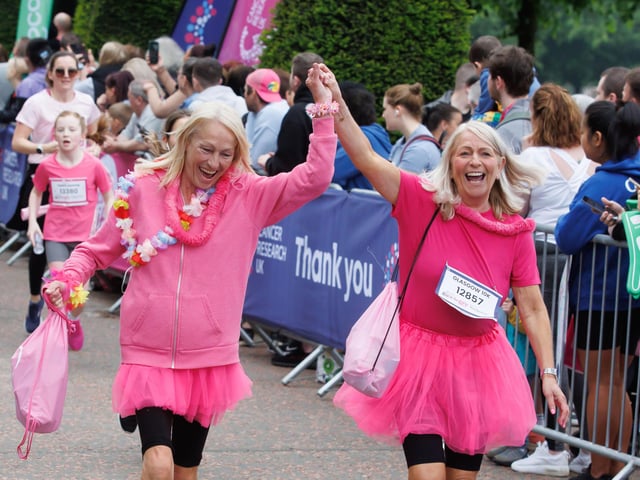 Friends drive each other on to cross the finishing line of the 10K. PIC: Steve Welsh.
