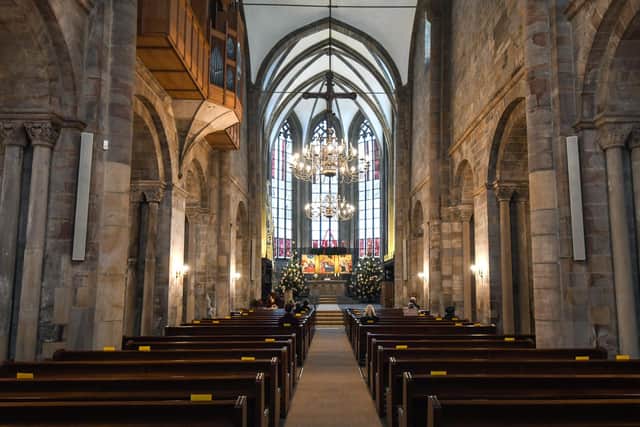 People sit at marked places to keep distance as they take part in a small church service. Picture: Ina Fassbender/AFP via Getty Images