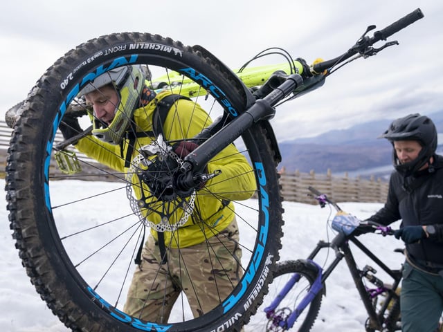 Cyclists climb their way to the start line to compete in MacAvalanche, a mass start mountain bike race through the snow, descending over 900m from the summit of Aonach Mor in the Nevis Range near Fort William. Jane Barlow/PA Wire