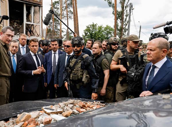 Italian Prime Minister Mario Draghi (2L) French President Emmanuel Macron (3L) and German Chancellor Olaf Scholz (R) visit Irpin on June 16, 2022. - It is the first time that the leaders of the three European Union countries have visited Kyiv since Russia's February 24 invasion of Ukraine.