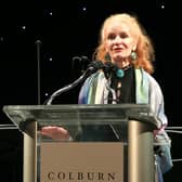 Carol Colburn Grigor speaks onstage in Los Angeles