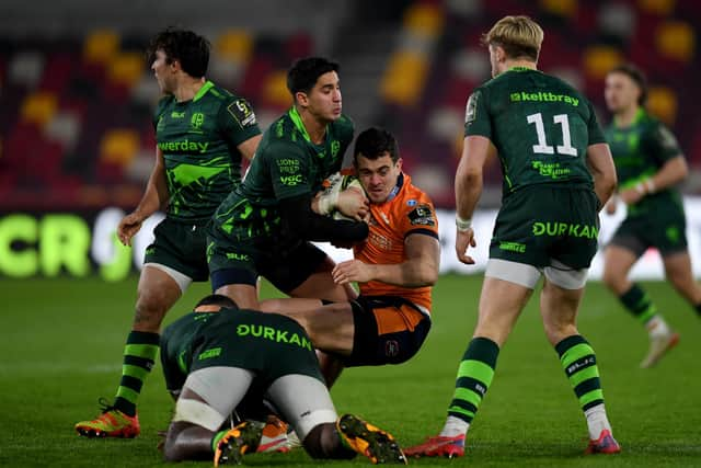 Emiliano Boffelli of Edinburgh Rugby is tackled by Lucioi Cinti of London Irish.