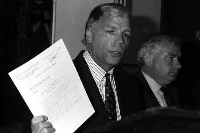Hearts chairman Wallace Mercer (left) announces plans to take over rivals Hibs in June 1990.