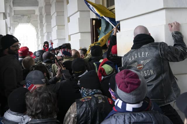 Demonstrators try to open a door of the U.S. Capitol on Wednesday, January 6, 2021, in Washington