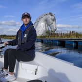 Scottish Canals activities assistant Rebecca Brown at the helm of one of its electric boats on the Forth & Clyde Canal at the Kelpies (Photo by Lisa Ferguson/The Scotsman)