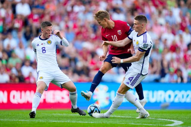 Scotland midfielders Callum McGregor and Scott McTominay challange Norway's Martin Odegaard. (Photo by FREDRIK VARFJELL/NTB/AFP via Getty Images)