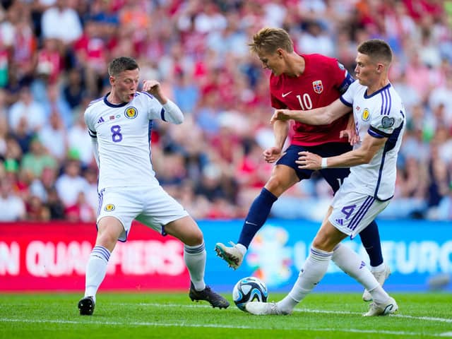 Scotland midfielders Callum McGregor and Scott McTominay challange Norway's Martin Odegaard. (Photo by FREDRIK VARFJELL/NTB/AFP via Getty Images)