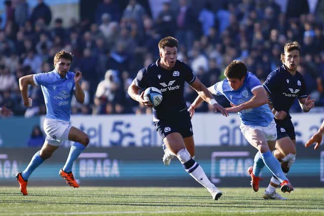 Huw Jones breaks through the Uruguayan rearguard.