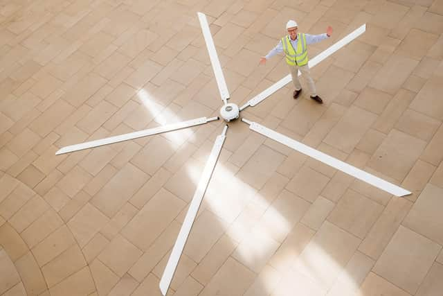 Dynamic Earth chief executive Mark Bishop shows off the giant 7m-wide rotor – one of five new fans due to be installed at the museum – that will be hoisted up inside the stratosphere's arched roof space to help make the heating system more efficient