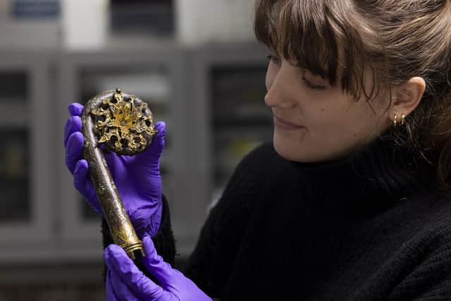 NMS conservation student Olivia Hope with the 12th century bishop's crozier. PIC: NMS/Duncan McGlynn.
