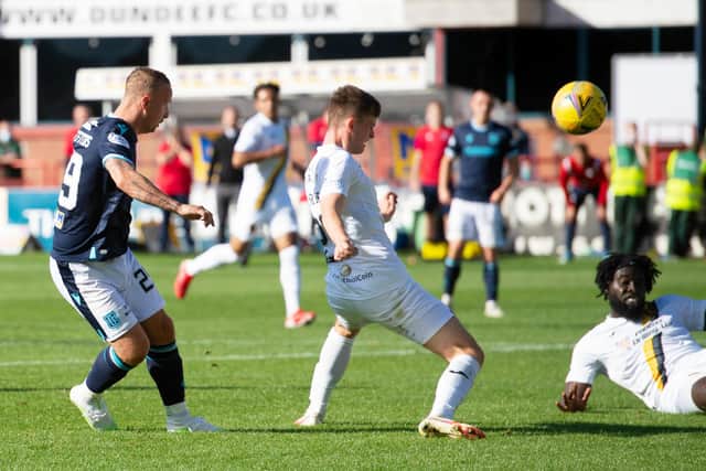 Dundee's Leigh Griffiths has a shot on goal against Livingston.