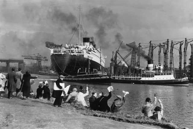 Crowds gather to watch the Cunard White Star liner Queen Mary leaving her fitting-out berth in the John Brown & Co shipyard at Clydebank in 1936 (Picture: Topical Press Agency/Getty Images)