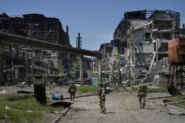 Russian soldiers patrol an area of the Metallurgical Combine Azovstal, in Mariupol, on the territory which is under the Government of the Donetsk People's Republic control, eastern Ukraine, on June 13, 2022.
