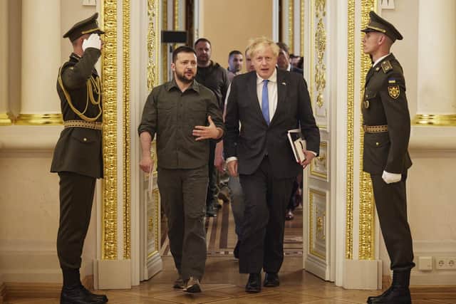 Ukrainian President Volodymyr Zelenskyy and Prime Minister Boris Johnson, walk after their meeting in Kyiv, Ukraine,