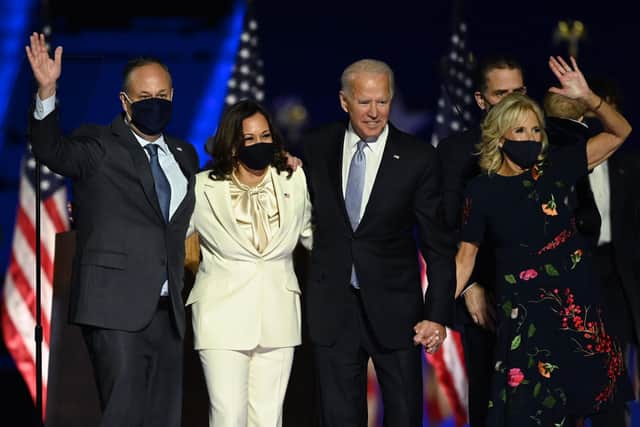 US President-elect Joe Biden and Vice President-elect Kamala Harris stand with spouses Jill Biden and Doug Emhoff after delivering remarks in Wilmington, Delaware (Photo by Jim WATSON / AFP) (Photo by JIM WATSON/AFP via Getty Images)