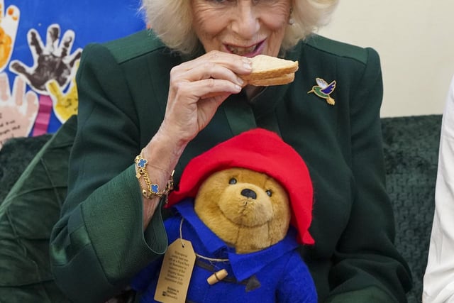 To mark the end of her visit, the Queen Consort shared marmalade sandwiches seated beside Mr Bonneville, Ms Harris and Ms Jankel, while around 40 children sat cross-legged at their feet..