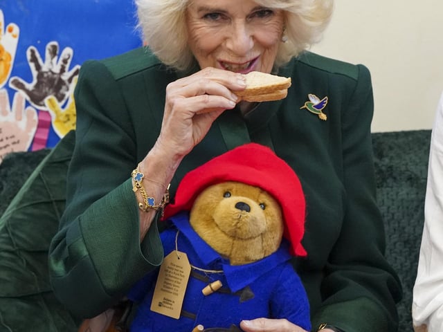 To mark the end of her visit, the Queen Consort shared marmalade sandwiches seated beside Mr Bonneville, Ms Harris and Ms Jankel, while around 40 children sat cross-legged at their feet..